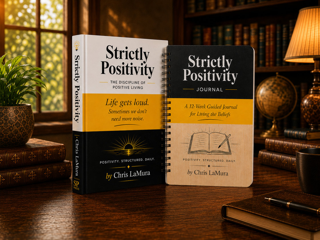 Strictly Positivity and the Strictly Positivity Journal standing together on a desk in a warm library